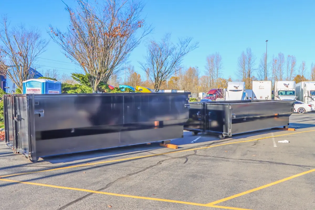 Professional dumpster rental service with roll-off container on residential driveway in Dunlap